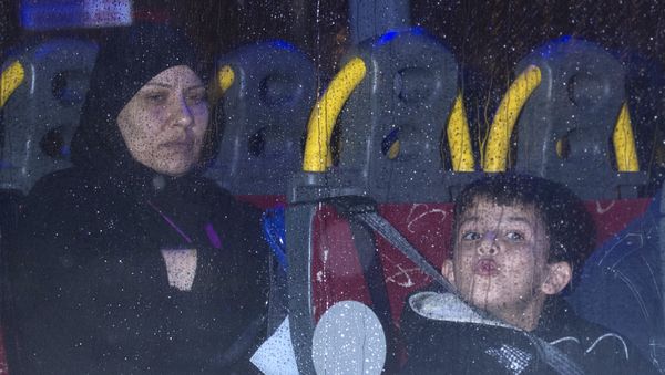 Syrian refugees are driven away after landing at Glasgow airport, Scotland on November 17, 2015. - Sputnik International