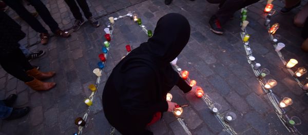 A person lights a candle during a candle light vigil to the victims of the Paris attacks in Brussels' Molenbeek district, on November 18, 2015. A person lights a candle during a candle light vigil to the victims of the Paris attacks in Brussels' Molenbeek district, on November 18, 2015. - Sputnik International
