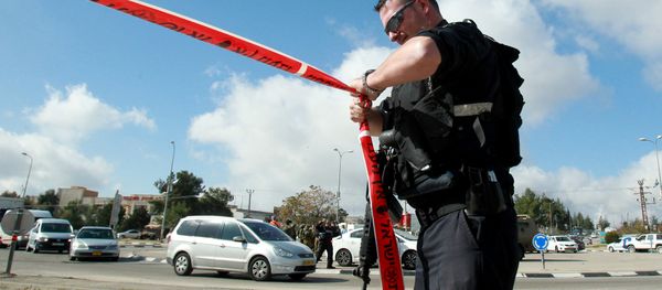An Israeli police officer holds police tape. An Israeli police officer holds police tape. - Sputnik International