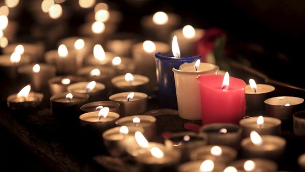 Candles are seen at a memorial tribute to the victims of attacks in Paris Candles are seen at a memorial tribute to the victims of attacks in Paris - Sputnik International