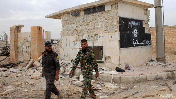 Syrian government forces walk past a building bearing an image on the wall with Islamic writing and reading in Arabic the Islamic State in the village of Jabboul on the eastern outskirts of the northern Syrian city of Aleppo after taking control of the village from Islamic State (IS) group islamists on October 24, 2015 Syrian government forces walk past a building bearing an image on the wall with Islamic writing and reading in Arabic the Islamic State in the village of Jabboul on the eastern outskirts of the northern Syrian city of Aleppo after taking control of the village from Islamic State (IS) group islamists on October 24, 2015 - Sputnik International