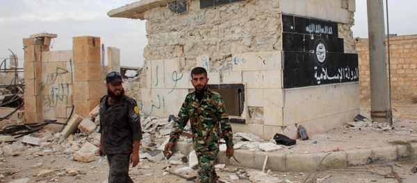 Syrian government forces walk past a building bearing an image on the wall with Islamic writing and reading in Arabic the Islamic State in the village of Jabboul on the eastern outskirts of the northern Syrian city of Aleppo after taking control of the village from Islamic State (IS) group islamists on October 24, 2015 Syrian government forces walk past a building bearing an image on the wall with Islamic writing and reading in Arabic the Islamic State in the village of Jabboul on the eastern outskirts of the northern Syrian city of Aleppo after taking control of the village from Islamic State (IS) group islamists on October 24, 2015 - Sputnik International
