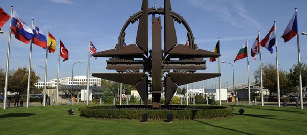 The NATO emblem is seen before a defence ministers meeting at the NATO headquarters in Brussels on October 22, 2013 - Sputnik International