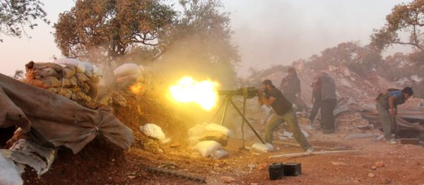 A rebel fighter fires a heavy machine gun during clashes with government forces and pro-regime shabiha militiamen in the outskirts of Syria's northwestern Idlib province on September 18, 2015 A rebel fighter fires a heavy machine gun during clashes with government forces and pro-regime shabiha militiamen in the outskirts of Syria's northwestern Idlib province on September 18, 2015 - Sputnik International