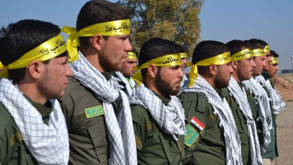 Fighters from the Iraqi Imam Ali Brigade, belonging to the Badr Organisation headed by former Iraqi Transport Minister Hadi al-Amiri, take part in a graduation ceremony in Taza Khurmatu, 20 kms south of Kirkuk, on February 26, 2015. - Sputnik International