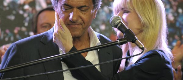 Buenos Aires province governor and presidential candidate for the Frente Para la Victoria (Front for Victory) Daniel Scioli (C) as he is comforted by his wife Karina Rabolini at the party's headquarters after admitting his defeat to his rival, the Head of Government of the Autonomous City of Buenos Aires and candidate for the Cambiemos (Let's Change) party Mauricio Macri, in Buenos Aires, on November 22, 2015. Buenos Aires province governor and presidential candidate for the Frente Para la Victoria (Front for Victory) Daniel Scioli (C) as he is comforted by his wife Karina Rabolini at the party's headquarters after admitting his defeat to his rival, the Head of Government of the Autonomous City of Buenos Aires and candidate for the Cambiemos (Let's Change) party Mauricio Macri, in Buenos Aires, on November 22, 2015. - Sputnik International