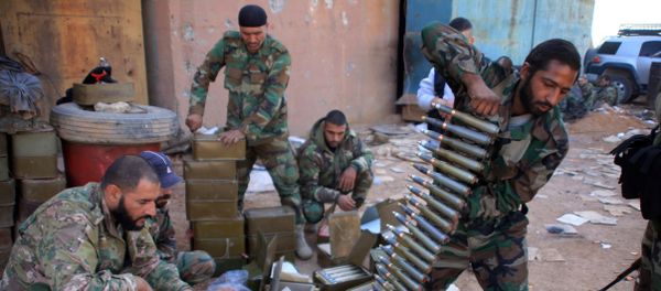 Syrian pro-government forces prepare their weapons at a train station in the area of Arkile near the airport of Kweyris, in the northern Syrian province of Aleppo, on November 20, 2015 Syrian pro-government forces prepare their weapons at a train station in the area of Arkile near the airport of Kweyris, in the northern Syrian province of Aleppo, on November 20, 2015 - Sputnik International