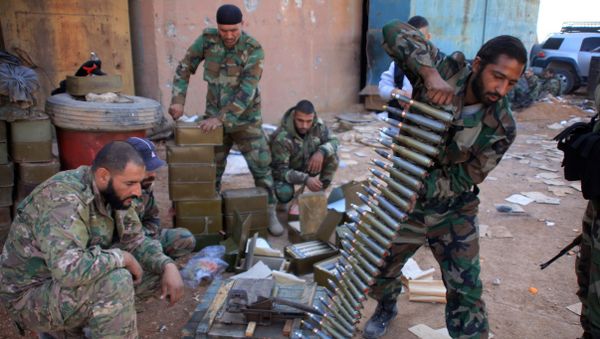 Syrian pro-government forces prepare their weapons at a train station in the area of Arkile near the airport of Kweyris, in the northern Syrian province of Aleppo, on November 20, 2015 Syrian pro-government forces prepare their weapons at a train station in the area of Arkile near the airport of Kweyris, in the northern Syrian province of Aleppo, on November 20, 2015 - Sputnik International