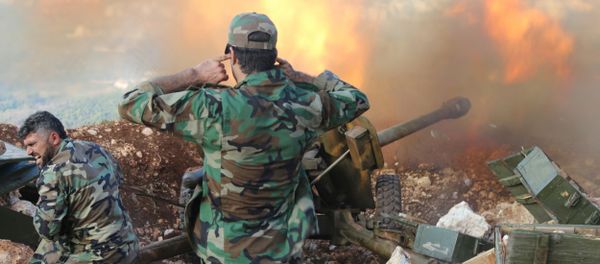 In this photo taken on Saturday, Oct. 10, 2015, Syrian army personnel fire a cannon in Latakia province, about 12 miles from the border with Turkey in Syria - Sputnik International