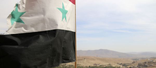 In this photo taken on Sunday, Oct. 18, 2015, a Syrian flag flies above the village of Maaloula, north of Damascus, Syria - Sputnik International