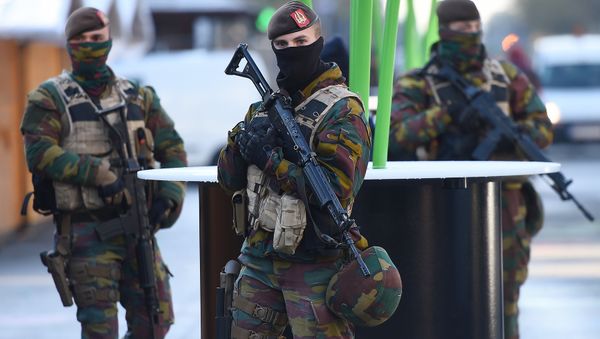 Soldiers patrol as the Belgian capital remains on the highest possible alert level on November 23, 2015 in Brussels - Sputnik International