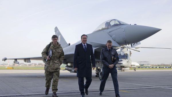 Britain's Prime Minister David Cameron (C) walks with Group Captain David Manning (R) past an RAF Eurofighter Typhoon fighter jet during his visit to Royal Air Force station RAF Northolt in London, Britain November 23, 2015 - Sputnik International