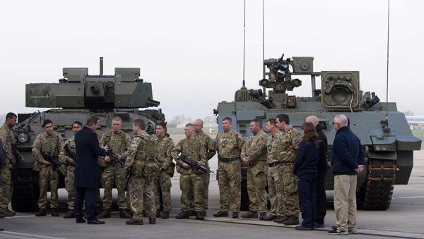 Britain's Prime Minister David Cameron (4th) chats with soldiers from the Royal Welsh Infantry as they stand in front of a Lockheed Martin Warrior Infantry Fighting Vehicle (L) and a General Dynamics Ajax Specialist Vehicle (SV) Armoured Fighting Vehicle, at RAF Northolt in London, Britain November 23, 2015 - Sputnik International
