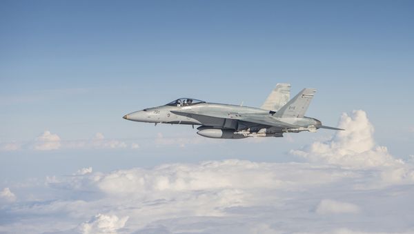 A Royal Canadian Air Force CF-188 Hornet flies over Iraq on November 7, 2015, during Operation IMPACT. - Sputnik International