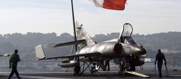 French sailors walk by a Super-Etendard jetfighter on the deck of France's nuclear-powered aircraft carrier Charles de Gaulle before to leave its home port of Toulon, southern France, Wednesday, Nov.18, 2015 French sailors walk by a Super-Etendard jetfighter on the deck of France's nuclear-powered aircraft carrier Charles de Gaulle before to leave its home port of Toulon, southern France, Wednesday, Nov.18, 2015 - Sputnik International