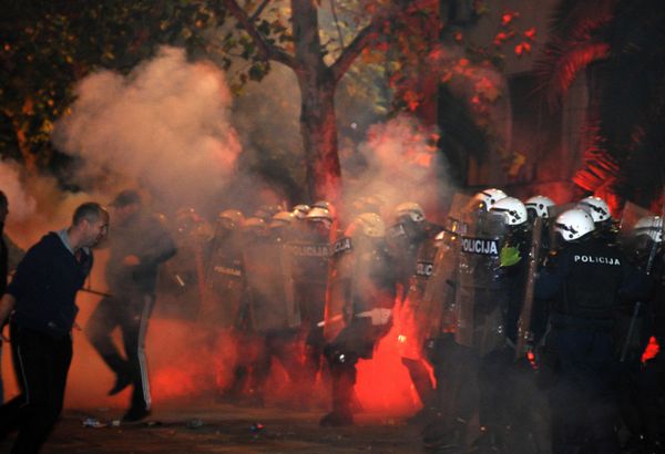 Montenegrin police officers are engulfed in smoke and flames as opposition supporters hurled torches on them during a protest in front of the Parliament building in Podgorica, Montenegro Saturday, Oct. 24, 2015. Police fired tear gas at opposition supporters who hurled fire bombs and torches to demand the resignation Prime Minister Milo Djukanovic's government which hopes to steer the Balkan country toward NATO membership later this year - Sputnik International