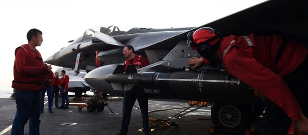 French navy engineers install a missile on a French Rafale fighter aircraft aboard the French Charles-de-Gaulle aircraft carrier, on November 23, 2015 at the eastern Mediterranean sea, as part of operation Chammal in Syria and Irak against the Islamic State group French navy engineers install a missile on a French Rafale fighter aircraft aboard the French Charles-de-Gaulle aircraft carrier, on November 23, 2015 at the eastern Mediterranean sea, as part of operation Chammal in Syria and Irak against the Islamic State group - Sputnik International