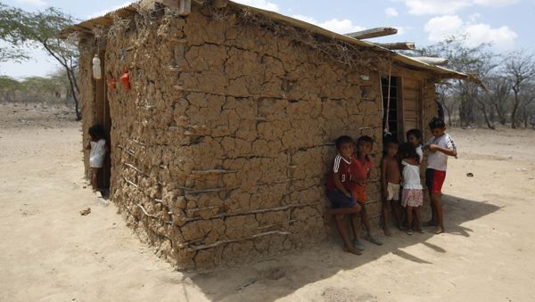 Wayuu indigenous children stand in the shade of their adobe home in Manaure, Colombia, Thursday, Sept. 10, 2015. Hunger exacerbated by a two-year-old drought is one of the biggest problems facing the Wayuu, a 600,000-strong ancestral tribe that’s caught in the middle of Venezuela’s crackdown on smuggling along its western border with Colombia Wayuu indigenous children stand in the shade of their adobe home in Manaure, Colombia, Thursday, Sept. 10, 2015. Hunger exacerbated by a two-year-old drought is one of the biggest problems facing the Wayuu, a 600,000-strong ancestral tribe that’s caught in the middle of Venezuela’s crackdown on smuggling along its western border with Colombia - Sputnik International