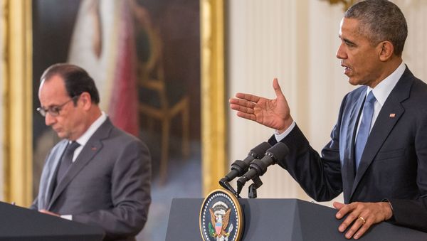 French President Francois Hollande listens as President Barack Obama speaks during their joint news conference in the East Room of the White House in Washington, Tuesday, Nov. 24, 2015 - Sputnik International