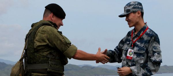 Russian and Chinese servicemen shake hands during the Russian-Chinese drill Naval Interaction-2015 at the Klerk testing grounds in Russia's Primorye Territory. Russian and Chinese servicemen shake hands during the Russian-Chinese drill Naval Interaction-2015 at the Klerk testing grounds in Russia's Primorye Territory. - Sputnik International