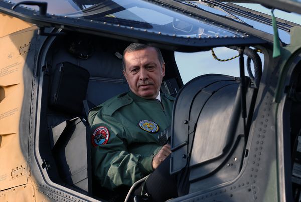 In this Tuesday, June 10, 2014 photo, Turkish Prime Minister Recep Tayyip Erdogan sits in the pilot's sesat during a presentation for the Turkish-made military attack helicopter, T129 ATAK, outside Ankara, Turkey - Sputnik International