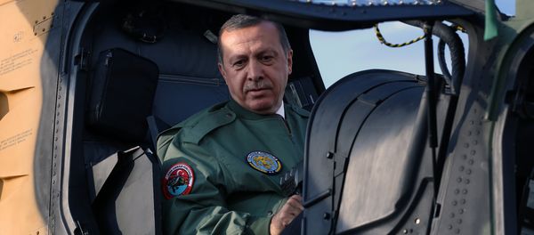 In this Tuesday, June 10, 2014 photo, Turkish Prime Minister Recep Tayyip Erdogan sits in the pilot's sesat during a presentation for the Turkish-made military attack helicopter, T129 ATAK, outside Ankara, Turkey In this Tuesday, June 10, 2014 photo, Turkish Prime Minister Recep Tayyip Erdogan sits in the pilot's sesat during a presentation for the Turkish-made military attack helicopter, T129 ATAK, outside Ankara, Turkey - Sputnik International