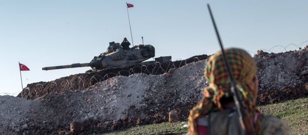 A Syrian Kurdish militia member of YPG patrols near a Turkish army tank as Turks work to build a new Ottoman tomb in the background in Esme village in Aleppo province, Syria, Sunday, Feb. 22, 2015 A Syrian Kurdish militia member of YPG patrols near a Turkish army tank as Turks work to build a new Ottoman tomb in the background in Esme village in Aleppo province, Syria, Sunday, Feb. 22, 2015 - Sputnik International