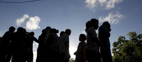 People stand near at a crime scene where seven men were killed, in Tegucigalpa, Honduras People stand near at a crime scene where seven men were killed, in Tegucigalpa, Honduras - Sputnik International