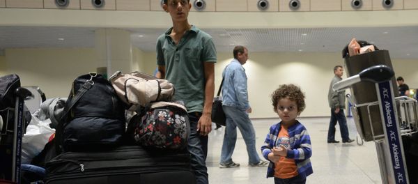 Syrian citizens who have been evacuated by a plane of the Russian Ministry for Civil Defense, Emergencies and Disaster Relief from Latakia, Syria, at Moscow's Domodedovo airport. - Sputnik International