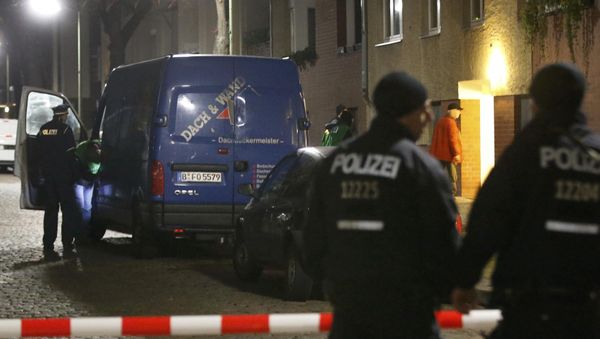 Police officers stand guard as colleagues search a suspicious vehicle during a raid on a building in Britz, south Berlin, Germany Police officers stand guard as colleagues search a suspicious vehicle during a raid on a building in Britz, south Berlin, Germany - Sputnik International