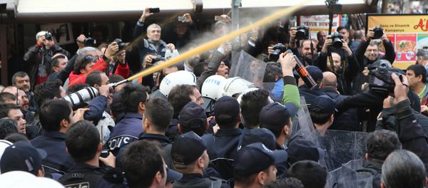 Police use tear-inducing agent against demonstrators during a protest against the arrest of journalists Can Dundar and Erdem Gul in Ankara on November 27, 2015. Police use tear-inducing agent against demonstrators during a protest against the arrest of journalists Can Dundar and Erdem Gul in Ankara on November 27, 2015. - Sputnik International