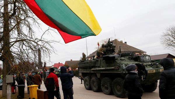 Local residents watch as a members of US Army’s 2nd Cavalry Regiment ride on an armored vehicle during the ''Dragoon Ride'' military exercise, in Salociai some 178 kms (110 miles) north of the capital Vilnius, Lithuania, Monday, March 23, 2015. - Sputnik International