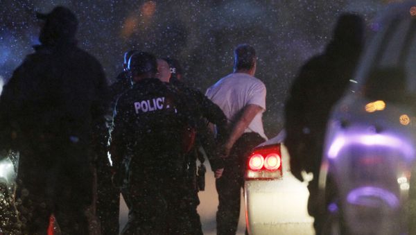 The handcuffed suspected gunman at the Planned Parenthood clinic is moved to a police vehicle in Colorado Springs, Colorado - Sputnik International