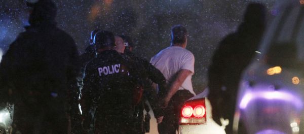 The handcuffed suspected gunman at the Planned Parenthood clinic is moved to a police vehicle in Colorado Springs, Colorado - Sputnik International