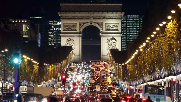 Christmas holiday lights hang from trees to illuminate Champs Elysees avenue in Paris as rush hour traffic fills the avenue leading up to the Arc de Triomphe, France, November 19, 2015 Christmas holiday lights hang from trees to illuminate Champs Elysees avenue in Paris as rush hour traffic fills the avenue leading up to the Arc de Triomphe, France, November 19, 2015 - Sputnik International
