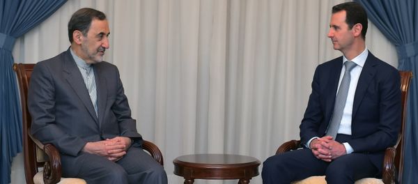In this file photo released on Tuesday, May 19, 2015 by the Syrian official news agency SANA, Syrian President Bashar Assad, right, meets with Ali Akbar Velayati, an adviser to Iran's Supreme Leader Ayatollah Ali Khamenei, in Damascus, Syria. In this file photo released on Tuesday, May 19, 2015 by the Syrian official news agency SANA, Syrian President Bashar Assad, right, meets with Ali Akbar Velayati, an adviser to Iran's Supreme Leader Ayatollah Ali Khamenei, in Damascus, Syria. - Sputnik International