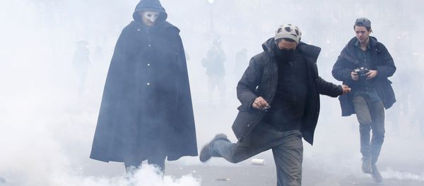 A demonstrator kicks a tear gas canister during clashes with CRS riot police near the Place de la Republique after the cancellation of a planned climate march following shootings in the French capital, ahead of the World Climate Change Conference 2015 (COP21), in Paris, France, November 29, 2015 - Sputnik International
