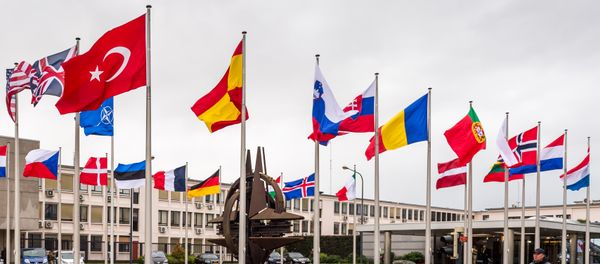NATO country flags wave outside NATO headquarters in Brussels on Tuesday July 28, 2015 - Sputnik International