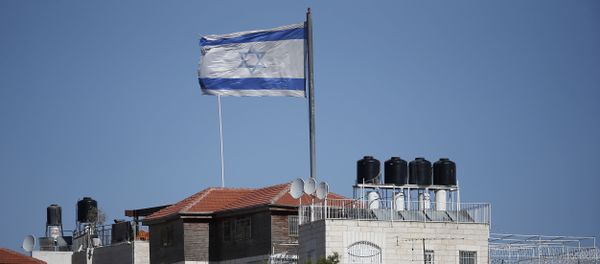 A giant Israeli flag flies over a settlement building situated in the middle of a Palestinian neighbourhood of Al-Tur in East Jerusalem, on November 11, 2014 - Sputnik International