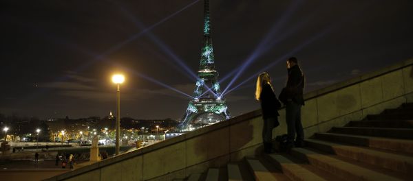 A couple stand on the stairs as an artwork entitled 'One Heart One Tree' by artist Naziha Mestaoui is displayed on the Eiffel tower as part of the COP21, United Nations Climate Change Conference. A couple stand on the stairs as an artwork entitled 'One Heart One Tree' by artist Naziha Mestaoui is displayed on the Eiffel tower as part of the COP21, United Nations Climate Change Conference. - Sputnik International
