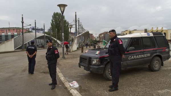 Kosovo police and Italian Carabineri stand near remains of a roadblock dismantled by Serbs in the tense city of Mitrovica Kosovo on Wednesday, June 18, 2014 Kosovo police and Italian Carabineri stand near remains of a roadblock dismantled by Serbs in the tense city of Mitrovica Kosovo on Wednesday, June 18, 2014 - Sputnik International