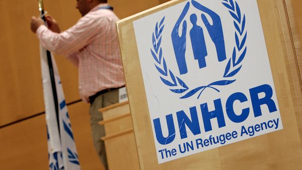 A staff installs a UNHCR flag close to a logo of UN High Commissioner for Refugees (UNHCR) prior to the opening of a two-day United Nations conference trying to boost support for Iraqis who have fled violence, 17 April 2007 at the UN Office in Geneva A staff installs a UNHCR flag close to a logo of UN High Commissioner for Refugees (UNHCR) prior to the opening of a two-day United Nations conference trying to boost support for Iraqis who have fled violence, 17 April 2007 at the UN Office in Geneva - Sputnik International