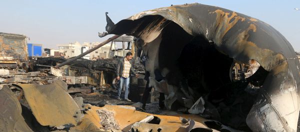A man inspects the damage after what activists said were air strikes carried out by the Russian air force, on a parking garage for cargo trucks in al-Dana town, near the Syrian-Turkish border in Idlib Governorate November 28, 2015 A man inspects the damage after what activists said were air strikes carried out by the Russian air force, on a parking garage for cargo trucks in al-Dana town, near the Syrian-Turkish border in Idlib Governorate November 28, 2015 - Sputnik International