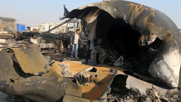 A man inspects the damage after what activists said were air strikes carried out by the Russian air force, on a parking garage for cargo trucks in al-Dana town, near the Syrian-Turkish border in Idlib Governorate November 28, 2015 A man inspects the damage after what activists said were air strikes carried out by the Russian air force, on a parking garage for cargo trucks in al-Dana town, near the Syrian-Turkish border in Idlib Governorate November 28, 2015 - Sputnik International