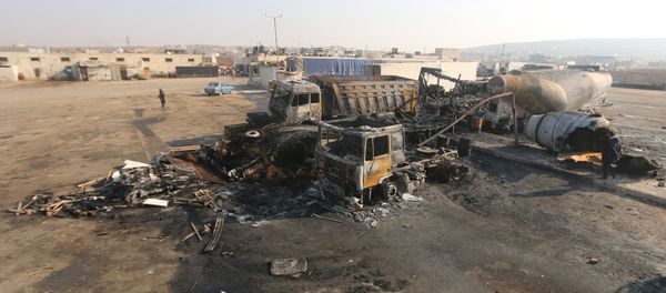 A general view shows damaged trucks after what activists said were air strikes carried out by the Russian air force, on a parking garage for cargo trucks in al-Dana town, near the Syrian-Turkish border in Idlib Governorate November 28, 2015 A general view shows damaged trucks after what activists said were air strikes carried out by the Russian air force, on a parking garage for cargo trucks in al-Dana town, near the Syrian-Turkish border in Idlib Governorate November 28, 2015 - Sputnik International