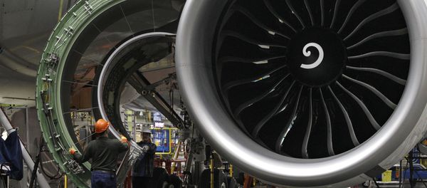 Worker maneuver the cover of a engine into place on a Boeing 777 jet at the company's manufacturing plant, Monday, Feb. 14, 2011, in Everett, Wash. Worker maneuver the cover of a engine into place on a Boeing 777 jet at the company's manufacturing plant, Monday, Feb. 14, 2011, in Everett, Wash. - Sputnik International