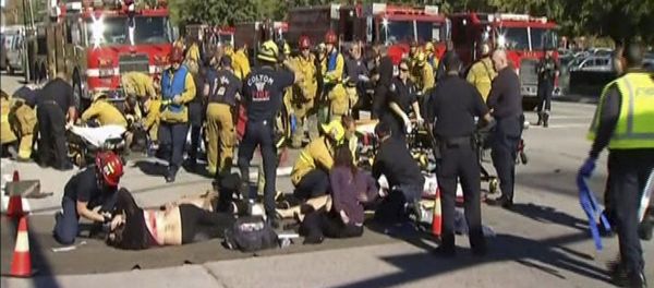 Still from video shows rescue crews tending to the injured in the intersection outside the Inland Regional Center in San Bernardino - Sputnik International