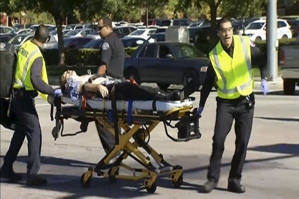 Still from video shows rescue crews tending to the injured in the intersection outside the Inland Regional Center in San Bernardino Still from video shows rescue crews tending to the injured in the intersection outside the Inland Regional Center in San Bernardino - Sputnik International