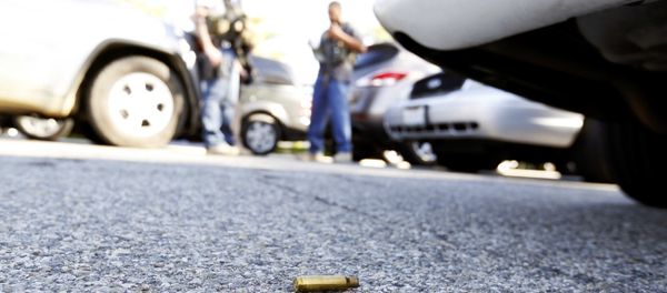 A spent cartrdige lies on the ground as police officers secure the area after at least one person opened fire at a social services agency in San Bernardino. A spent cartrdige lies on the ground as police officers secure the area after at least one person opened fire at a social services agency in San Bernardino. - Sputnik International