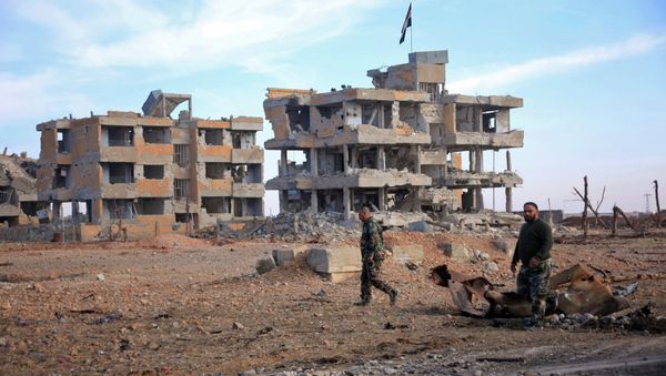 Syrian army soldiers patrol the countryside of Deir Hafer, a former bastion of Daesh, near the northern Syrian city of Aleppo on December 2, 2015 - Sputnik International